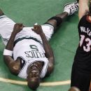 Boston Celtics forward Kevin Garnett (5) yells after hitting the floor hard while vying for a rebound against the Miami Heat during the second quarter of Game 3 in the NBA basketball playoffs Eastern Conference finals, in Boston on Friday, June 1, 2012. At right is Heat guard Mike Miller.(AP Photo/Charles Krupa)