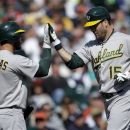 Oakland Athletics' Seth Smith (15) celebrates his solo home run against the Detroit Tigers with teammate George Kottaras in the fifth inning of a baseball game in Detroit, Thursday, Sept. 20, 2012. (AP Photo/Paul Sancya)