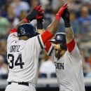 Boston Red Sox's David Ortiz (34) greets teammate Mike Napoli at the plate after Napoli cleared the bases with a grand slam in the third inning of a baseball game against the New York Yankees at Yankee Stadium in New York, Saturday, June 1, 2013. (AP Photo/Paul J. Bereswill)