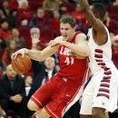 New Mexico's Cameron Bairstow, left, drives around Fresno State's Kevin Foster in the first half of an NCAA college basketball game in Fresno, Calif., Wednesday, Feb. 13, 2013. (AP Photo/Gary Kazanjian)
