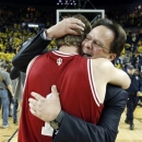 Indiana coach Tom Crean, right, hugs guard Jordan Hulls (1) after a come-from-behind, 72-71 win over Michigan in an NCAA college basketball game Sunday, March 10, 2013, in Ann Arbor, Mich. (AP Photo/Duane Burleson)