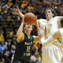 Wright State guard Kendall Griffin, left, drives the lane while Valparaiso forward Kevin Van Wijk defends during first half action in a NCAA college basketball game Tuesday March 12, 2013 in Valparaiso, Ind. (AP Photo/Joe Raymond)