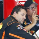 Driver Tony Stewart, left, talks with his crew chief Steve Addington during a break in practice for the NASCAR Sprint cup series Quaker State 400 at the Kentucky Speedway in Sparta, Ky., Friday, June 28, 2013. (AP Photo/James Crisp)