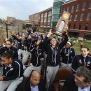 Connecticut's Stefanie Dolson holds the championship trophy as she rides with the team on a double-decker bus during a parade through campus honoring the team's win in the NCAA women's college basketball tournament, in Storrs, Conn., Wednesday, April 10, 2013. (AP Photo/Jessica Hill)