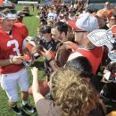 Cleveland Browns quarterback Brandon Weeden signs autographs for fans after NFL football training camp on Sunday, July 29, 2012, in Berea, Ohio. (AP Photo/Tony Dejak)