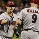 Arizona Diamondbacks' Chris Johnson, left, rounds third to greetings from third base coach Matt Williams (9) after hitting a three-run home run off Pittsburgh Pirates relief pitcher Jason Grilli (39) in the eighth inning of a baseball game in Pittsburgh, Tuesday, Aug. 7, 2012. (AP Photo/Gene J. Puskar)