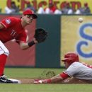 Los Angeles Angels Mike Trout (27) steals second base against Texas Rangers Ian Kinsler during the first inning of game one of a baseball double header Sunday, Sept. 30, 2012, in Arlington, Texas. (AP Photo/LM Otero)