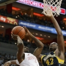 Louisville's Russ Smith, left, attempts a shot over the defense of Marquette's Chris Otule during the second half of their NCAA college basketball game on Sunday, Feb. 3, 2013, in Louisville, Ky. Louisville defeated Marquette 70-51. (AP Photo/Timothy D. Easley)