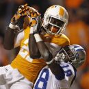 FILE- In this Nov. 15, 2011, file photo, Tennessee wide receiver Da'Rick Rogers (21) catches a pass for a touchdown while defended by Middle Tennessee cornerback Kenneth Gilstrap (18) in the first quarter of an NCAA college football game in Knoxville, Tenn. Tennessee has suspended Rogers for an unspecified violation of team rules. (AP Photo/Wade Payne, File)
