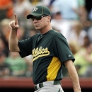 FILE - In this March 17, 2012, file photo, Oakland Athletics manager Bob Melvin gestures during a spring training baseball game in Scottsdale, Ariz. Melvin has received a two-year contract extension through the 2016 season after leading Oakland to a surprising AL West title last year. The A's announced Monday, Jan. 14, 2013, that Melvin, the reigning AL Manager of the Year, received a new deal. (AP Photo/Marcio Jose Sanchez, File)