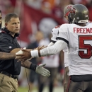FILE - In this Sept. 15, 2013 file photo, Tampa Bay Buccaneers head coach Greg Schiano, left, shakes hands with quarterback Josh Freeman (5) after Freeman threw a touchdown pass to wide receiver Kevin Ogletree during the first quarter of an NFL football game against the New Orleans Saints, in Tampa, Fla. The Buccaneers have benched Freeman and replaced him with rookie Mike Glennon. The move Wednesday, Sept. 25, 2013, came two days after Schiano insisted Freeman remained the starter because he gave the team the best chance to win. (AP Photo/Chris O'Meara, File)