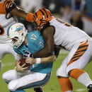 Miami Dolphins quarterback Ryan Tannehill (17) is sacked by Cincinnati Bengals defensive tackle Geno Atkins during the first half of an NFL football game, Thursday, Oct. 31, 2013, in Miami Gardens, Fla. (AP Photo/Wilfredo Lee)