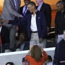President Barack Obama waves to the crowd as he watches the first half of the East Regional final in the NCAA men's college basketball tournament between Syracuse and Marquette, Saturday, March 30, 2013, in Washington. (AP Photo/Mark Tenally)