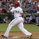 Texas Rangers' Adrian Beltre follows through on his solo home run off a pitch from Tampa Bay Rays' David Price in the second inning of a baseball game, Monday, Aug. 27, 2012, in Arlington, Texas. (AP Photo/Tony Gutierrez)