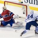 Toronto Maple Leafs' Mikhail Grabovski (84) scores against Montreal Canadiens goaltender Carey Price during third period NHL hockey game action in Montreal, on Saturday, March 3, 2012. (AP Photo/The Canadian Press, Graham Hughes)
