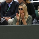 Maria Sharapova of Russia, center, applauds as her boyfriend Grigor Dimitrov of Bulgaria faces Grega Zemlja of Slovenia during their Men's second round singles match at the All England Lawn Tennis Championships in Wimbledon, London, Friday, June 28, 2013. (AP Photo/Sang Tan)