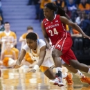 Tennessee's Kamiko Williams and Rutgers' Shakena Richardson chase after a loose ball during their NCAA college basketball game in Knoxville, Tenn., Sunday, Dec. 30, 2012. (AP Photo/The Knoxville News Sentinel, Saul Young)