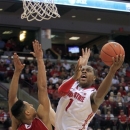 Ohio State's Deshaun Thomas, right, shoots over Wisconsin's Ryan Evans during the second half of an NCAA college basketball game Tuesday, Jan. 29, 2013, in Columbus, Ohio. Ohio State defeated Wisconsin 58-49. (AP Photo/Jay LaPrete)