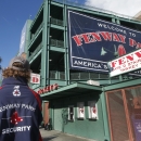 A security guard keeps an eye on things outside Gate D at Fenway Park in Boston, Tuesday, Oct. 29, 2013. If the Boston Red Sox are able to win the baseball World Series at at the stadium, police and city officials want to make sure fans celebrate responsibly. Boston holds a 3-2 lead over the St. Louis Cardinals with Game 6 and if necessary Game 7 scheduled at Fenway for Wednesday and Thursday nights. Police plan to put extra patrols on duty to guard against any unruly celebrations. (AP Photo/Elise Amendola)