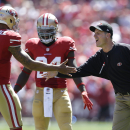 San Francisco 49ers head coach Jim Harbaugh, right, celebrates with quarterback Colin Kaepernick (7) after Kaepernick's 20-yard touchdown pass to tight end Vernon Davis during the first quarter of an NFL football game against the Green Bay Packers in San Francisco, Sunday, Sept. 8, 2013. (AP Photo/Marcio Jose Sanchez)