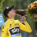 Team Sky rider Chris Froome of Britain, the race leader's yellow jersey, celebrates his overall victory on the podium after the final 21st stage of the 102nd Tour de France cycling race from Sevres to Paris Champs-Elysees, France, July 26, 2015. REUTERS/Benoit Tessier