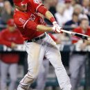 Los Angeles Angels' Mike Trout hits an RBI single against the Seattle Mariners in the fourth inning of a baseball game, Monday, Oct. 1, 2012, in Seattle. (AP Photo/Elaine Thompson)
