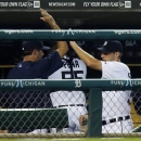 Detroit Tigers starter Max Scherzer, right, gets a high-five from Justin Verlander after pitching the seventh inning of a baseball game against the Boston Red Sox, Saturday, June 22, 2013, in Detroit. The Tigers 10-3 win gave Scherzer his 11th straight decision, the first time a Tigers pitcher has won 11 consecutive games to begin a season. (AP Photo/Duane Burleson)