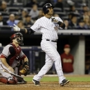 New York Yankees' Robinson Cano watches his fourth-inning, three-run home run off Arizona Diamondbacks starting pitcher Brandon McCarthy in a baseball game at Yankee Stadium in New York, Tuesday, April 16, 2013. Arizona catcher Miguel Montero, left, watches from behind the plate. (AP Photo/Kathy Willens)