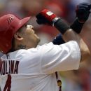 St. Louis Cardinals' Yadier Molina celebrates as he reaches home after hitting a solo home run during the second inning of a baseball game against the Pittsburgh Pirates, Sunday, July 1, 2012, in St. Louis. (AP Photo/Jeff Roberson)