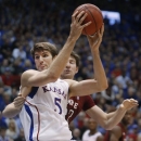 Kansas center Jeff Withey (5) works in front of Temple forward Jake O'Brien during the first half of an NCAA college basketball game in Lawrence, Kan., Sunday, Jan. 6, 2013. (AP Photo/Orlin Wagner)