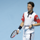 Japan's Kei Nishikori walks back on court after a game break as he plays against Britain's Andy Murray during their ATP World Tour tennis finals match at the O2 arena in London, Sunday, Nov., 9, 2014. (AP Photo/Alastair Grant)