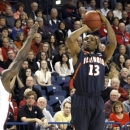 Illinois' Tracy Abrams (13) puts up a shot as Gonzaga's Guy Landry Edi defends in the first half of an NCAA college basketball game, Saturday, Dec. 8, 2012, in Spokane, Wash. (AP Photo/Jed Conklin)