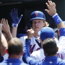 Teammates congratulate New York Mets starting pitcher Noah Syndergaard in the dugout after he hit a fourth-inning solo home run off Philadelphia Phillies starting pitcher Sean O'Sullivan in a baseball game in New York, Wednesday, May 27, 2015. (AP Photo/Kathy Willens)