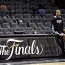 San Antonio Spurs' Tony Parker watches from the sideline during NBA basketball practice Wednesday, June 12, 2013, in San Antonio. The Spurs lead the Miami Heat 2-1 in the best-of-seven games series. Game 4 of the NBA finals series is scheduled for Thursday. (AP Photo/David J. Phillip)