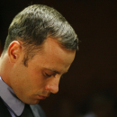 FILE - In this Feb. 21, 2013 file photo, Olympic athlete Oscar Pistorius stands during his bail hearing at the magistrate court in Pretoria, South Africa A judge in South Africa says Pistorius, who is charged with murdering his girlfriend, can leave South Africa to compete in international competition, with conditions. (AP Photo/Themba Hadebe, File)