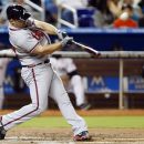 Atlanta Braves' Dan Uggla hits a three-run home run during the first inning of a baseball game against the Miami Marlins, Monday, Sept. 17, 2012, in Miami. (AP Photo/Wilfredo Lee)
