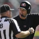 FILE - This Aug. 26, 2012 file photo shows San Francisco 49ers head coach Jim Harbaugh, right, arguing with a replacement official during the second quarter of an NFL preseason football game against the Denver Broncos,  in Denver. The NFL will open the regular season with replacement officials. League executive Ray Anderson has told the 32 teams that with negotiations remaining at a standstill between the NFL and the officials' union. The replacements will be on the field beginning next Wednesday night, Sept. 5, 2012 when the Cowboys visit the Giants to open the season. (AP Photo/Joe Mahoney, File)