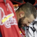 FILE - In this Oct. 21, 2012, file photo, St. Louis Cardinals' Chris Carpenter wipes his face with a towel in the dugout during the fourth inning of Game 6 of baseball's National League championship series against the San Francisco Giants in San Francisco. Carpenter is unlikely to pitch for the Cardinals this season and his career may be over because of a nerve injury that kept him out most of last year, general manager John Mozeliak said Tuesday, Feb. 5, 2013. (AP Photo/David J. Phillip, File)