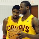 Cleveland Cavaliers guard Kyrie Irving, left, watches guard Dion Waiters as they have their photos taken during their NBA basketball media day at the team's training facility in Independence, Ohio, Monday, Oct. 1, 2012. (AP Photo/Phil Long)