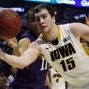Iowa's Zach McCabe (15) and Northwestern's Reggie Hearn (11) go after a loose ball during the first half of an NCAA college basketball game at the Big Ten tournament Thursday, March 14, 2013, in Chicago. (AP Photo/Charles Rex Arbogast)