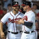 CORRECTS INNING TO SEVENTH - Atlanta Braves' Evan Gattis and Brian McCann, right, smile after scoring against the Toronto Blue Jays in the seventh inning of a baseball game at Turner Field in Atlanta, Thursday, May 30, 2013. (AP Photo/David Tulis)