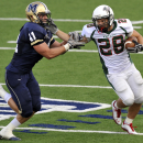 Minot State running back Tyson Schatz (28) stiff-arms Montana State's Brad Daly (41) for a gain in the second half of an NCAA college football game Saturday, Sept. 17, 2011, in Bozeman, Mt. (AP Photo/Dean Hendrickson)