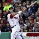 Boston Red Sox's Daniel Nava follows through on a three-run home run during the seventh inning of a baseball game against the Baltimore Orioles at Fenway Park in Boston, Monday, April 8, 2013. (AP Photo/Elise Amendola)