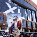 A vendor sells program books for the NFL Super Bowl XLVI football game between the New England Patriots and the New York Giants outside of Lucas Oil Stadium, Sunday, Feb. 5, 2012, in Indianapolis. (AP Photo/Michael Conroy)