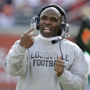 Louisville coach Charlie Strong directs his team against Connecticut during an NCAA college football game in Louisville, Ky., Saturday, Nov. 24, 2012. UConn 23-20 in triple overtime. (AP Photo/Garry Jones)