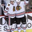 Chicago Blackhawks right wing Patrick Kane, right, celebrates his goal with teammate Marian Hossa during the second period of an NHL hockey game against the Toronto Maple Leafs, Wednesday, Feb. 29, 2012, in Chicago. (AP Photo/Charles Rex Arbogast)