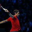 Switzerland's Roger Federer follows his shot to Japan's Kei Nishikori during their singles ATP World Tour tennis finals match at the O2 arena in London, Tuesday, Nov. 11, 2014. (AP Photo/Alastair Grant)
