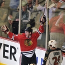 Chicago Blackhawks' Bryan Bickell reacts after scoring the game-winning goal as the Minnesota Wild's Jonas Brodin (25) skates by during overtime of Game 1 of an NHL hockey Stanley Cup playoff series Tuesday, April 30, 2013, in Chicago. The Blackhawks defeated the Wild 2-1. (AP Photo/Jim Prisching)