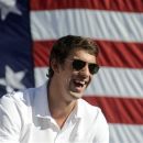 FILE - This Sept. 10, 2012 file photo shows Michael Phelps smiling during a celebration of the achievements of Maryland Olympians, in Baltimore. The most decorated Olympian will join David Feherty for a special, Ryder Cup-themed edition of 