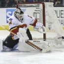 Calgary Flames goalie Miikka Kiprusoff (34), from Finland, against the San Jose Sharks during an NHL hockey game in San Jose, Calif., Friday, April 5, 2013. (AP Photo/Jeff Chiu)